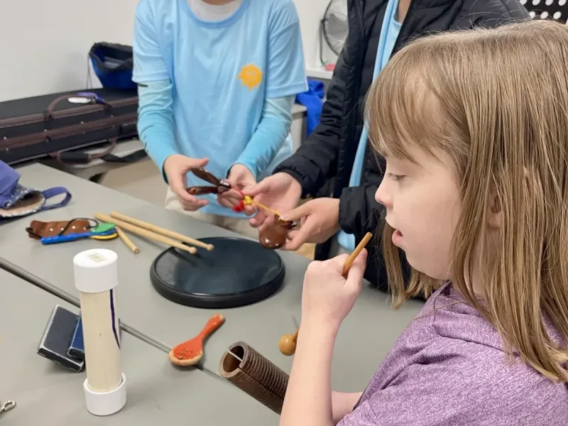 Children learning musical instruments in class