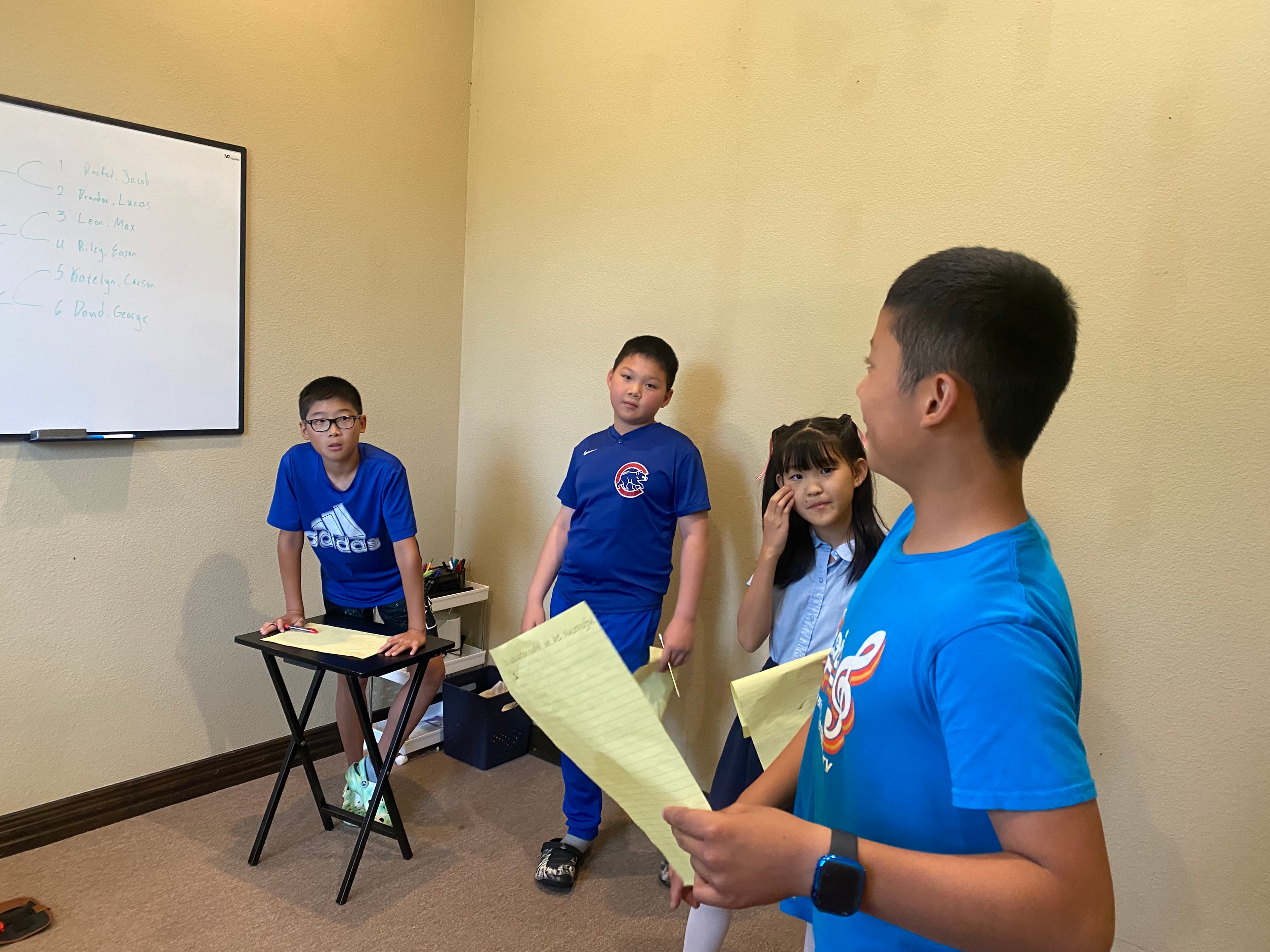 Student speaking confidently at a microphone on stage