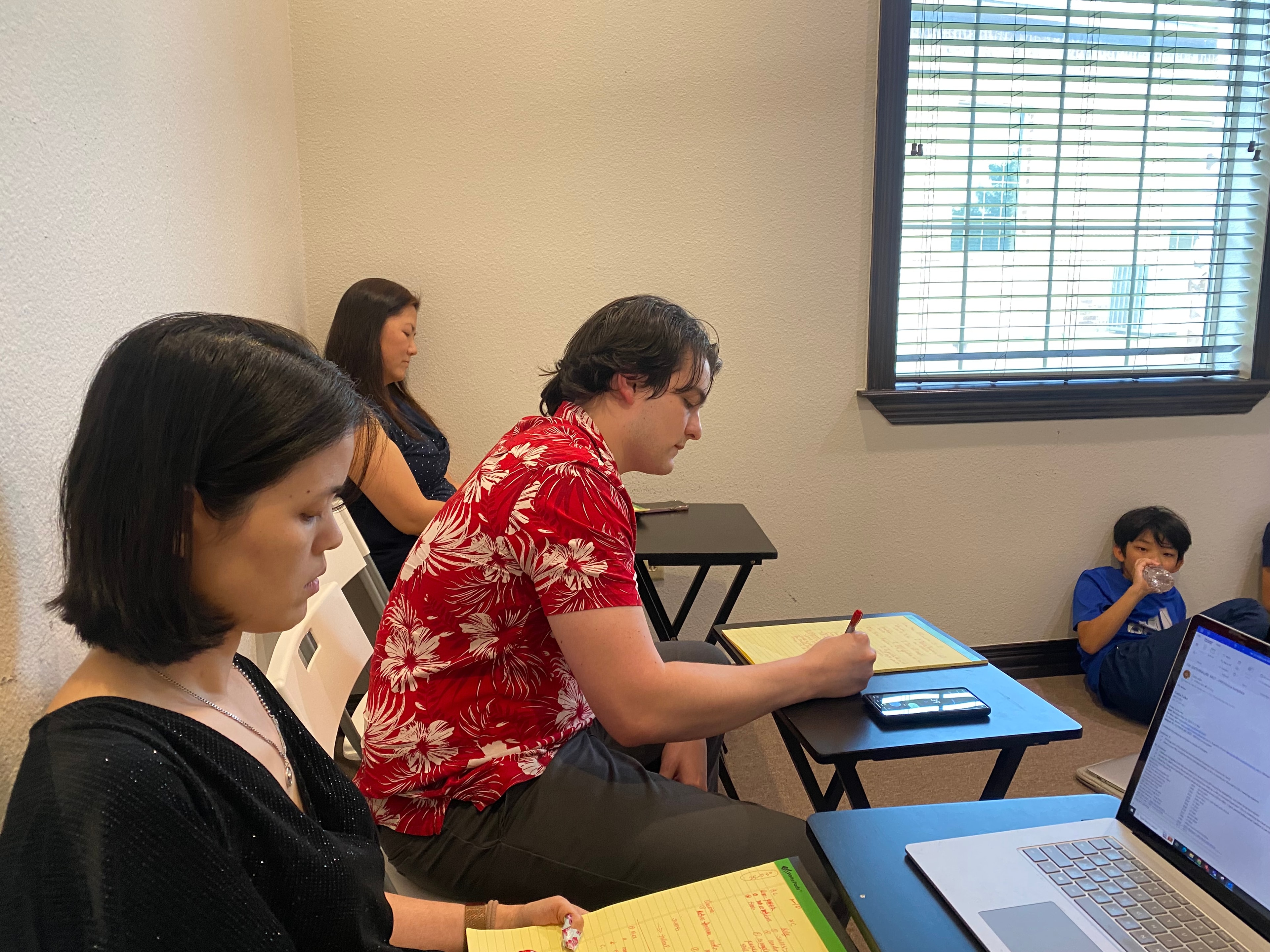 Volunteers coaching students in a workshop setting